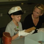 A young historian analyzes a WWII ration.