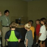 Red Ball Express Coordinator Collin Makamson takes the Young Historians through the special exhibit.