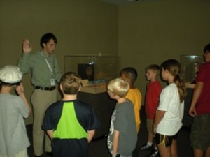 Red Ball Express Coordinator Collin Makamson takes the Young Historians through the special exhibit.