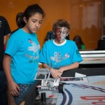 Members of the Titanium Owls from Lake Harbor Middle School watch their robot deliver the canister.
