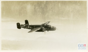 View looking over unto a B-25 Mitchell bomber in flight. Location unknown. 1943-45. Gift of Charles Szumigala, from the collection of The National WWII Museum.