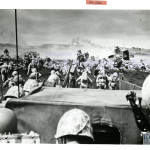 A WAVE OF CHARGING FOURTH DIVISION MARINES BEGINS AN ATTACK FROM THE BEACH AT IWO JIMA ON D-DAY, 19 FEBRUARY 1945. U.S. Navy Official photograph, Gift of Charles Ives, from the collection of The National World War II Museum.