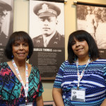 Sandra Holliday and her daughter Alanna Griffith standing at Medal of Honor Recipient Charles Thomas's feature in the Museum's special exhibit. They are the niece and great-niece of Charles Thomas.