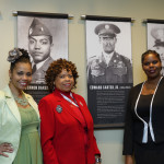 Relatives of Edward A. Carter, Jr. standing with his feature in the Museum special exhibit.