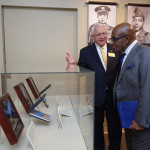 Dr. Nick Mueller, president and CEO of The National WWII Museum, showing Al Roker the five out of seven Medals of Honor awarded to African Americans during World War II on view in the Museum's special exhibit.