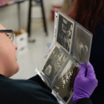 A teacher workshop participant examines WWII artifacts from the Museum's collection.