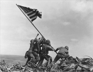 U.S. Marines of the 28th Regiment, 5th Division, raise the American flag atop Mt. Suribachi, Iwo Jima, on Feb. 23, 1945. Strategically located only 660 miles from Tokyo, the Pacific island became the site of one of the bloodiest, most famous battles of World War II against Japan. (AP Photo/Joe Rosenthal)